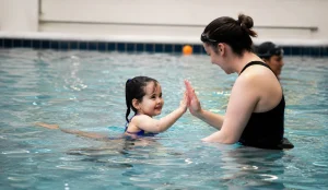 water adaptation classes child smiling in warm indoor pool